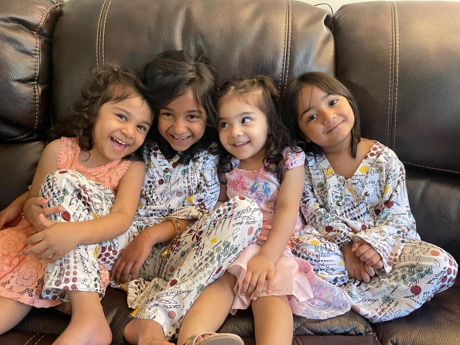 Children sharing and playing together in a cozy corner.